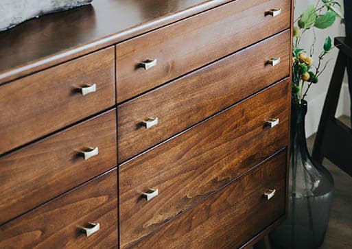 walnut cabinet with modern silver knobs
