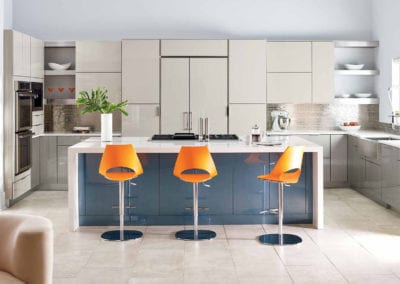 modern kitchen with blue island and orange barstools