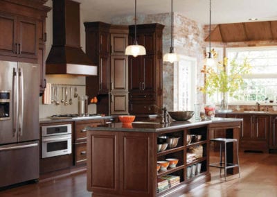 custom french style kitchen with dark wood cabinets and large island with storage