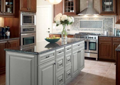 custom kitchen with dark wood cabinets and light grey custom island