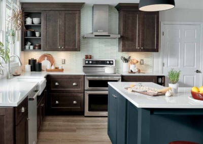 dark brown kitchen cabinets with custom navy blue island