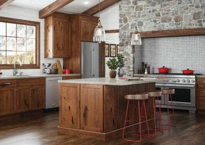 rustic kitchen with dark wood cabinets and stone wall