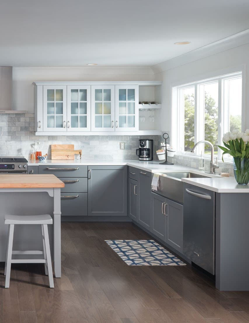 grey kitchen cabinets with marble backsplash