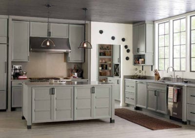 spacious industrial style kitchen with grey cabinets