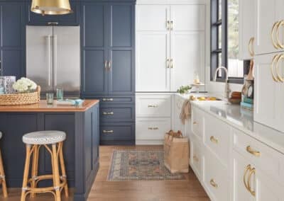 white and blue kitchen cabinets with gold hardware