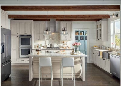 modern farmhouse kitchen with cream cabinets and exposed wood beams