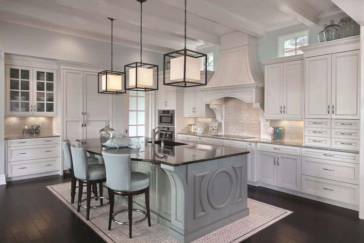 french style kitchen with built-in cabinets and blue island